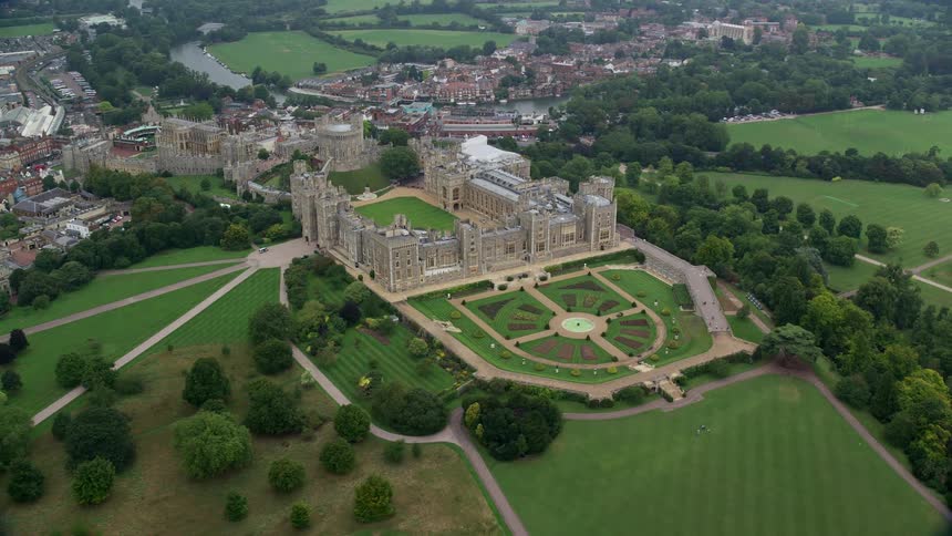 Landscaped historic estate stands near housing and river