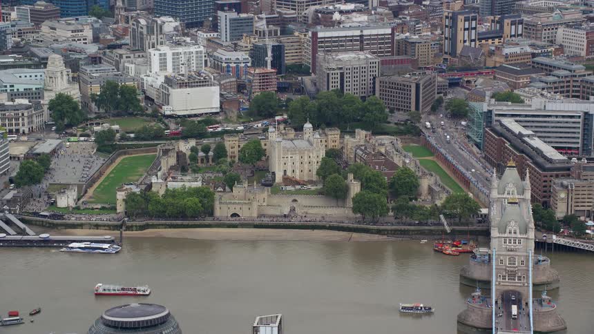 Traffic crosses london bridge over the thames near historic landmark buildings in london