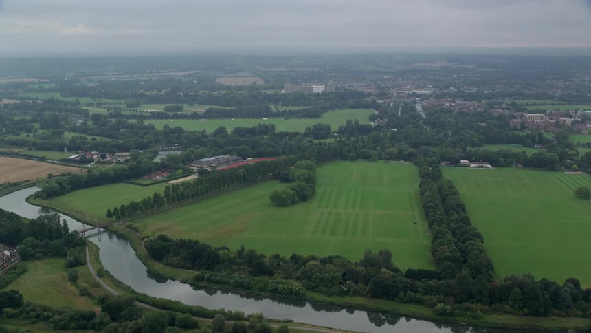 Aerial view of a road with vehicles in the middle of a river and rural fields
