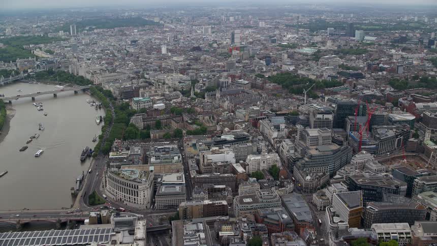 Aerial view of a city on the edge of a lake with buildings and residential areas