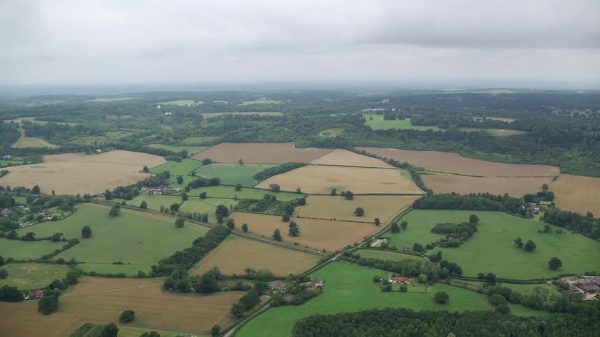 Aerial of rural town with plantation and making on a cloudy day