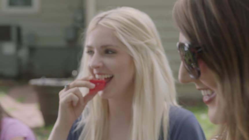 Women eat fruit drink and talk