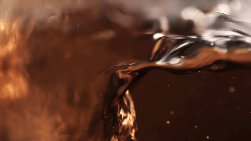 Clear liquid splashes around in slow motion