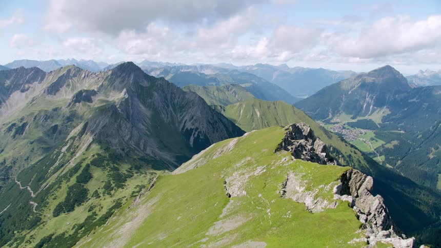 Aerial of green mountains on a foggy day