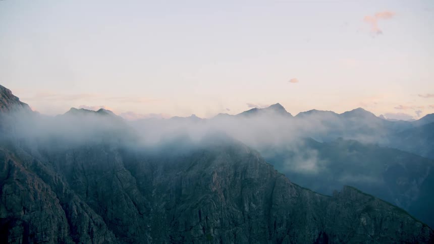 The clouds touch the top of the mountain