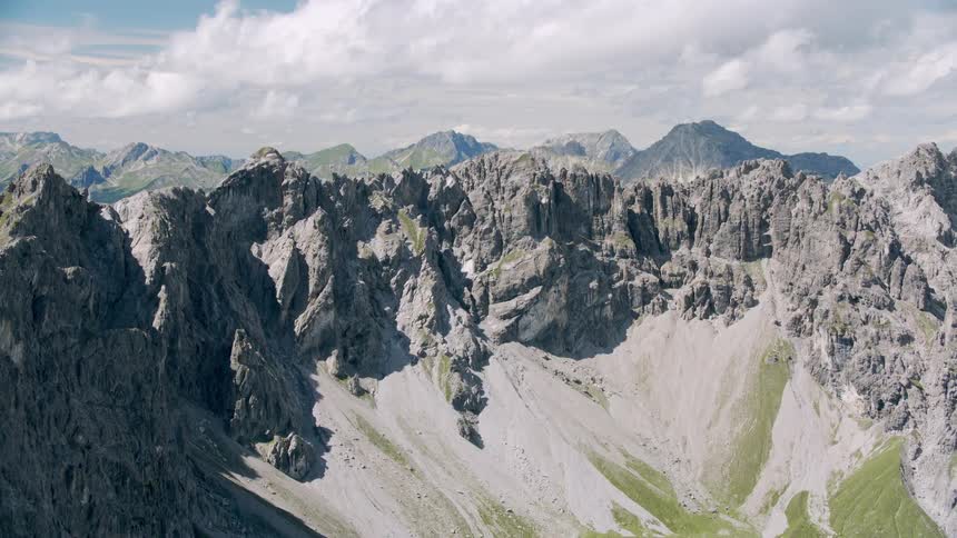 An extensive rock formation of mountainous height