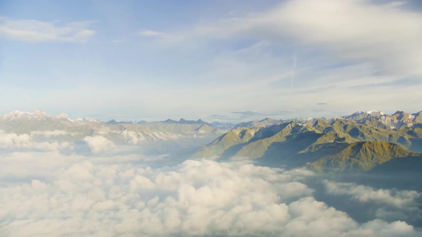 The green mountains are covered with fog