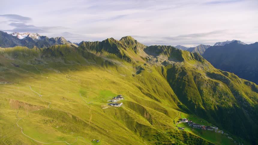 Aerial view of a landscape with mountains and a small village