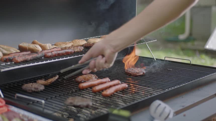 A person is cooking on a grill