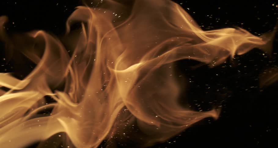 Orange flames create a shower of sparks in the darkness