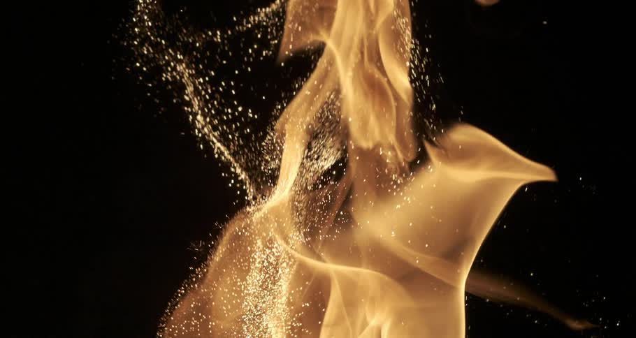 A flame of fire with lots of sparks going upwards