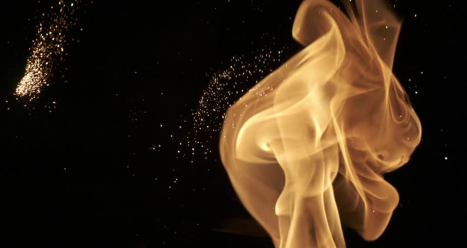 An incandescent fire with many sparks shooting upwards and to the sides