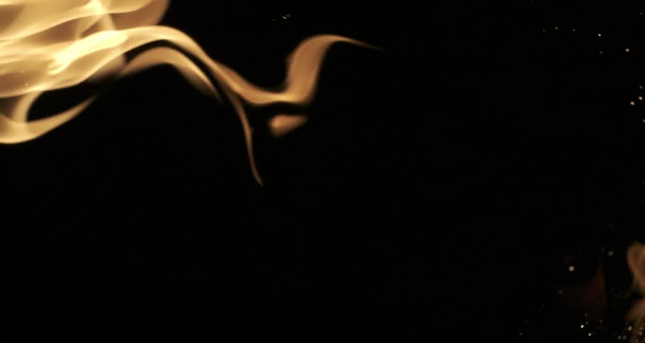 Glowing embers rise from orange flames as they float and twist across the darkness