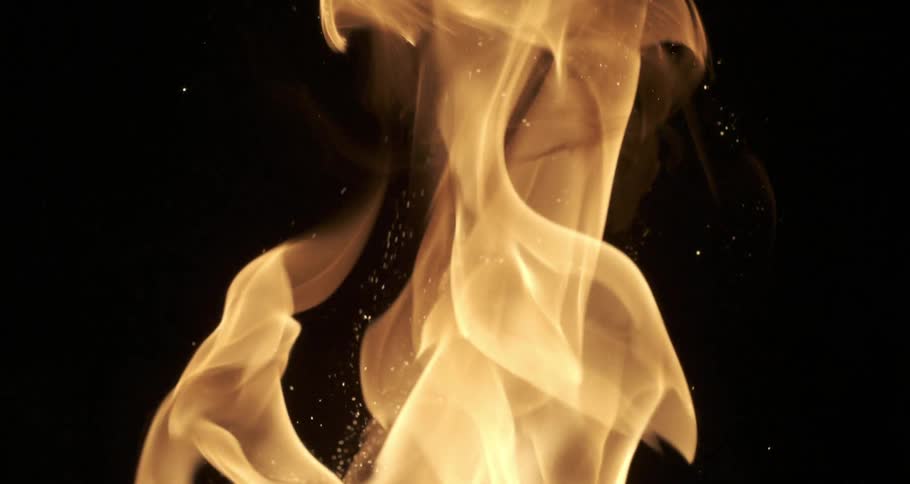 Many particles of fire sparks coming out of a fire fireplace on a black background