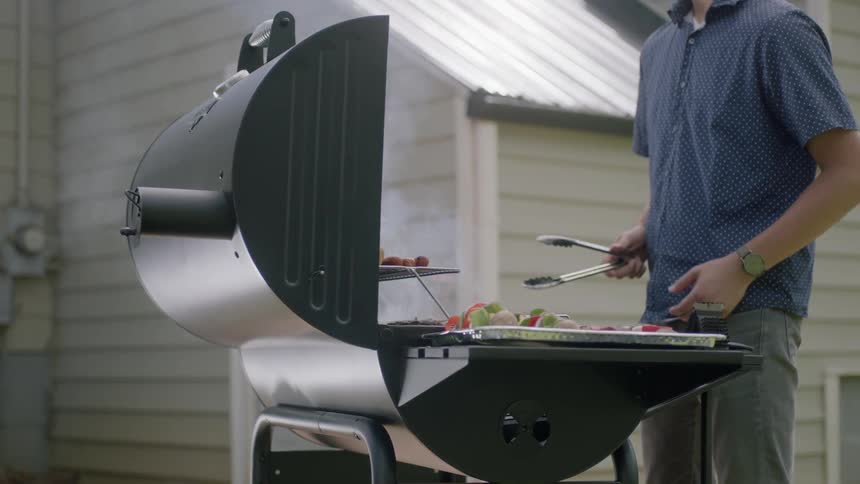 A man is using a barbecue cooking food