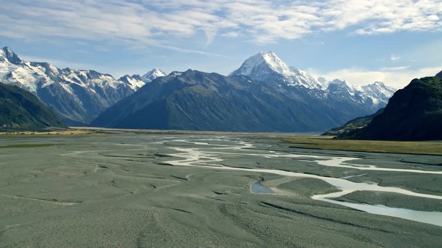 Streams cross through rocky plain near mountains in New Zealand