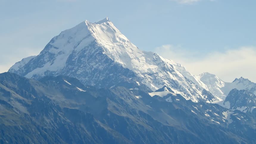 Snow covered mountain towers over the alpine landscape