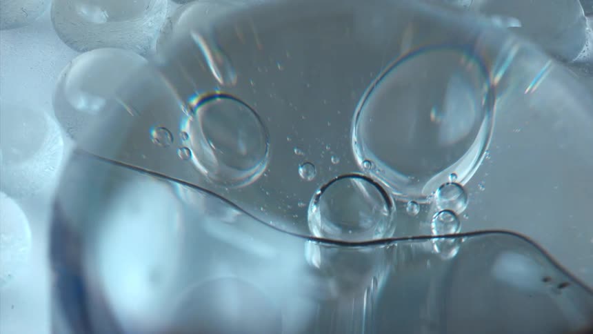 Several bluish and transparent bubbles in a fluid
