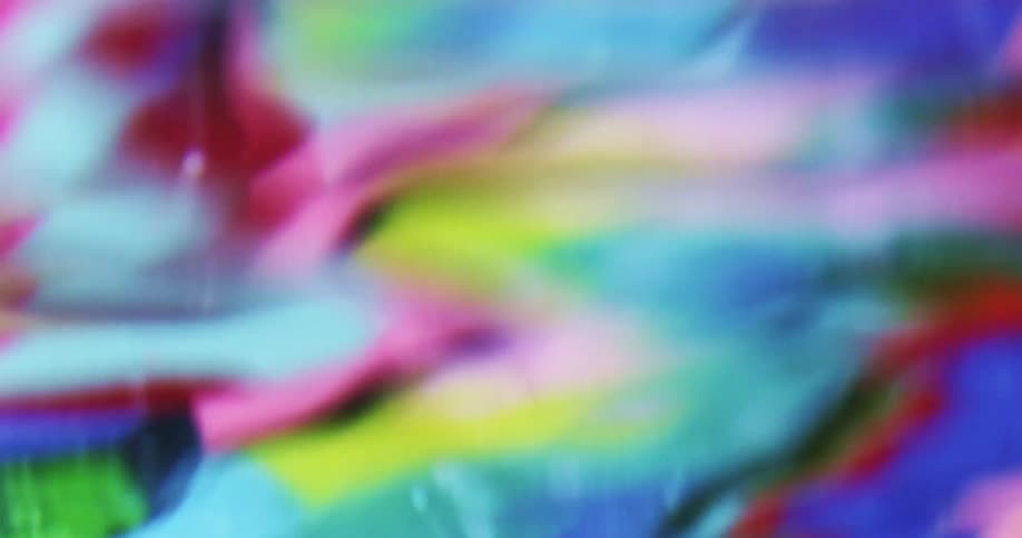 Several different blurred colors reflecting in water