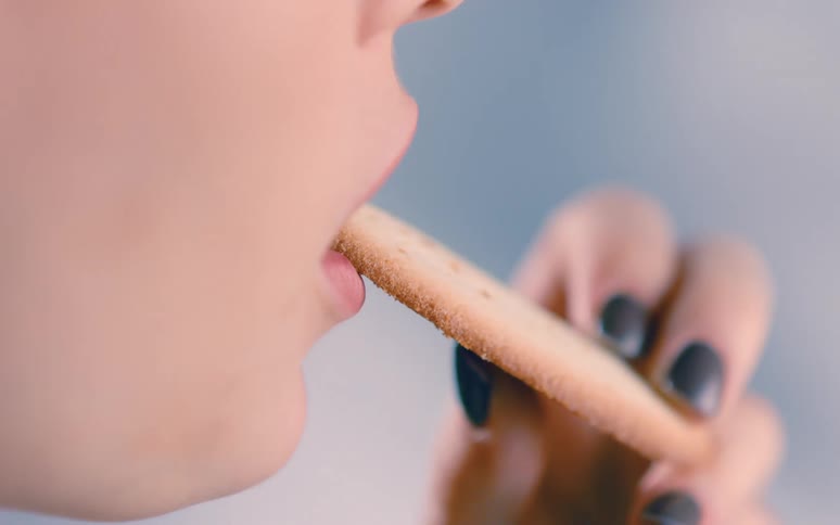 A person eating a cookie