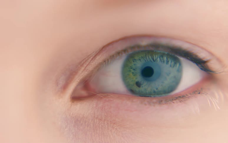 Extreme closeup of the lightcolored eyes of a person