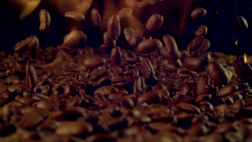 Flames burst from roasted coffee beans
