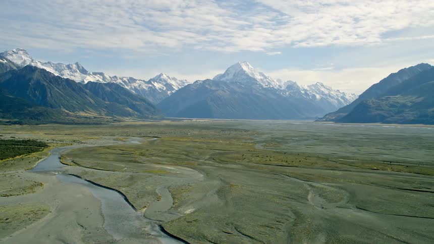 Aerial view of a river in the plains next to the Mt Cook mountain range