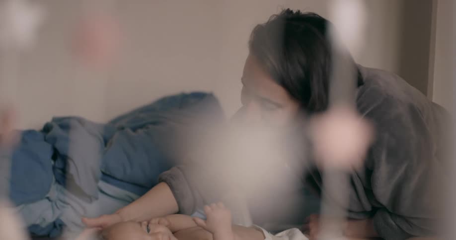 A mother cuddling her baby son