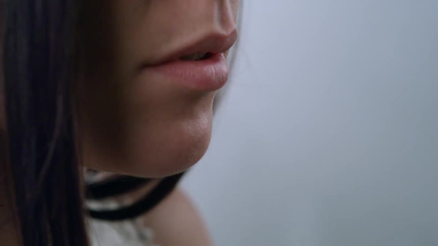 A part of a womans face with lips and skin and quince