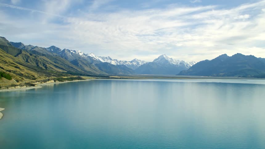 Aerial of lake with blue water in nature with mountains in New Zealand