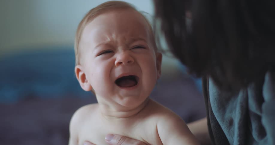 A mother comforting her crying baby
