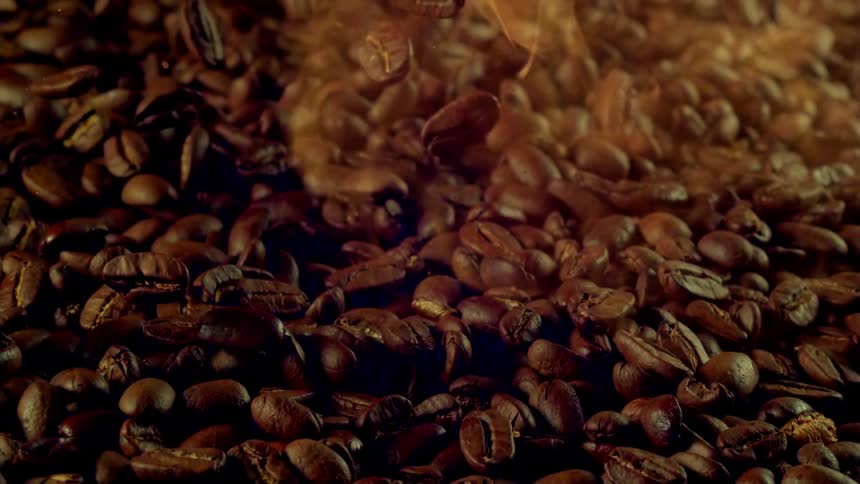 Coffee beans with some in slow motion