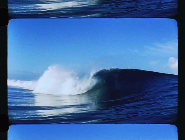 A wave breaking in the blue sea and making white foam
