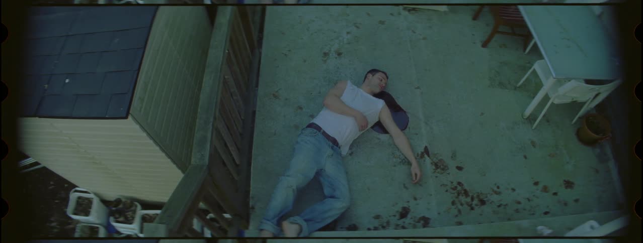 A man is laying on the floor bleeding