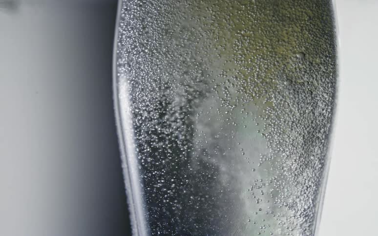 Transparent liquid inside an abstract container in motion with bubbles