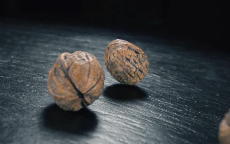 Nuts falling on a black surface