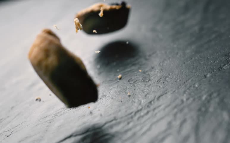 Two small pies falling onto a reflected stone floor