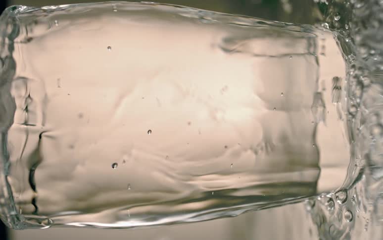 Water spills from an overfilled glass