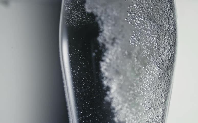 Several bubbles bubbling in a liquid inside a glass container