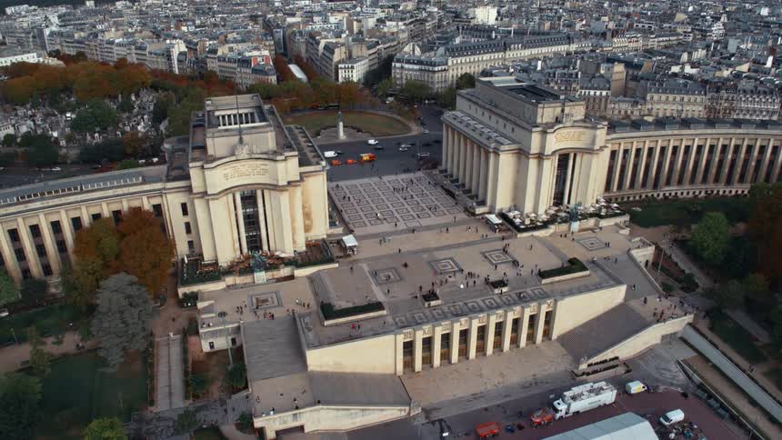 The paris trocadero with several cars passing behind