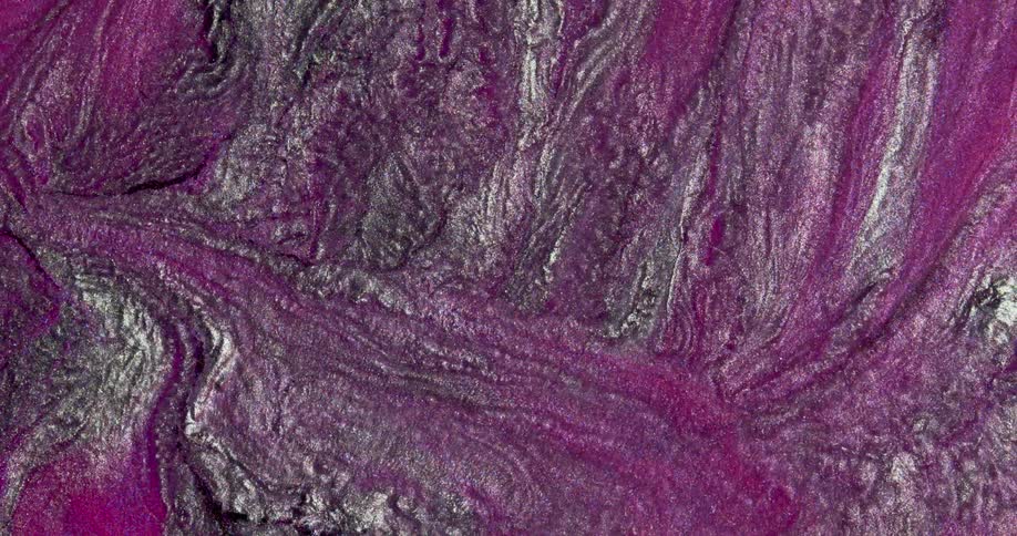 Iridescent shimmering metallic glitter inks flowing in abstract shapes