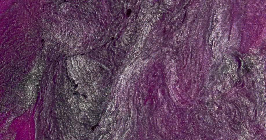 Iridescent shimmering metallic glitter inks flowing in abstract shapes