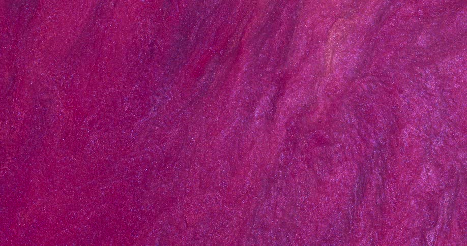 Macro close up of swirling metallic shimmer inks