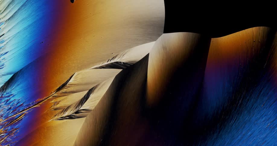 Smoothly growing crystals of liquid chemical watched with microscope