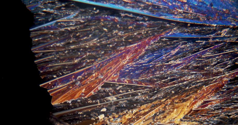 Growing colorful crystals forming under a microscopic small view