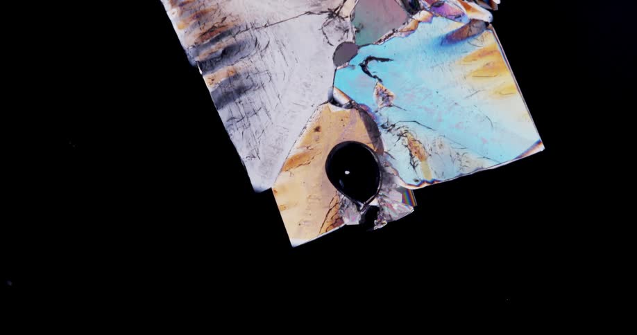Growing colorful crystals forming under a microscopic small view