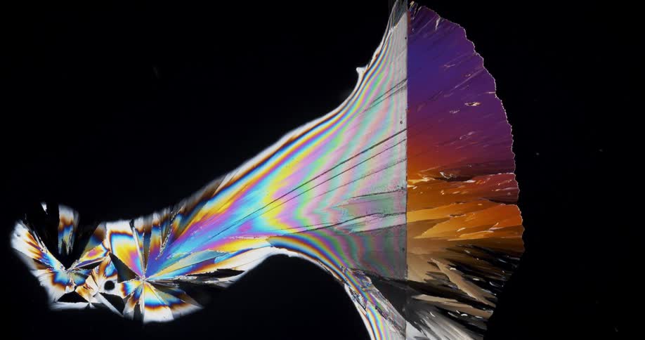 Growing colorful crystals forming under a microscopic small view