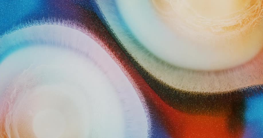 Expanding circles of abstract pearlescent ink drops flowing background