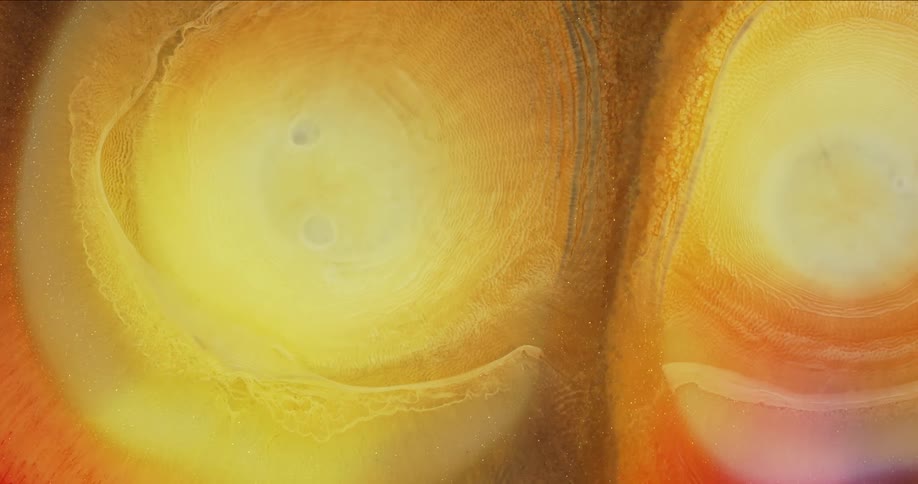 Expanding circles of abstract pearlescent ink drops flowing background