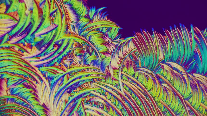 Abstract patterns of crystals from salicylic acid under microscope